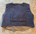 Load image into Gallery viewer, flat back view of the blue chambray double breasted waistcoat showing the lining and button detail for the back tabs