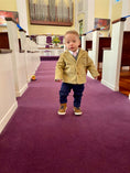 Load image into Gallery viewer, toddler walking down the isle of church with tan corduroy sportscoat and blue chambray pants or jeans
