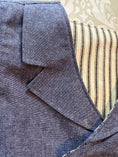 Load image into Gallery viewer, a closeup of the collar detail on the blue chambray double breasted waistcoat. this shows the topstitching detail