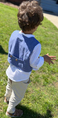 Load image into Gallery viewer, little boy showing the back version of the double breasted waistcoat with back tabs or straps with wood buttons