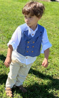 Load image into Gallery viewer, little boy wearing the blue chambray double breasted waistcoat, white linen button down shirt and natural linen adventure pants
