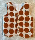 Load image into Gallery viewer, flat view front of orange printed vest with natural wood buttons down the front