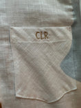 Load image into Gallery viewer, Close up of the pocket and monogram in a light khaki color thread