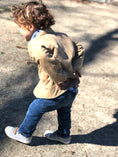 Load image into Gallery viewer, Toddler boy walking showing the back detail of a tan corduroy sportscoat
