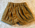 Load image into Gallery viewer, Flat lay view of the pleated cuffed shorts showing the elastic waist at the back 
