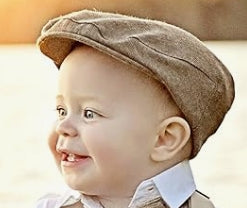 baby wearing a light brown tweed newsboy cap
