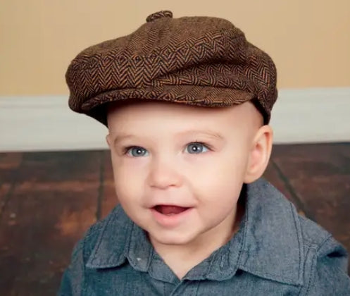 baby boy wearing a dark brown herringbone tweed newsboy cap