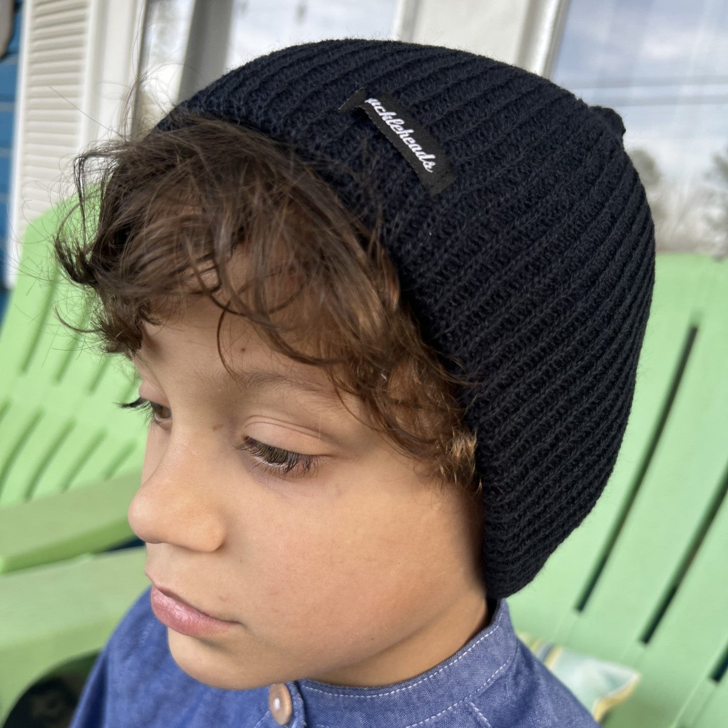 boy wearing a navy blue slouch beanie