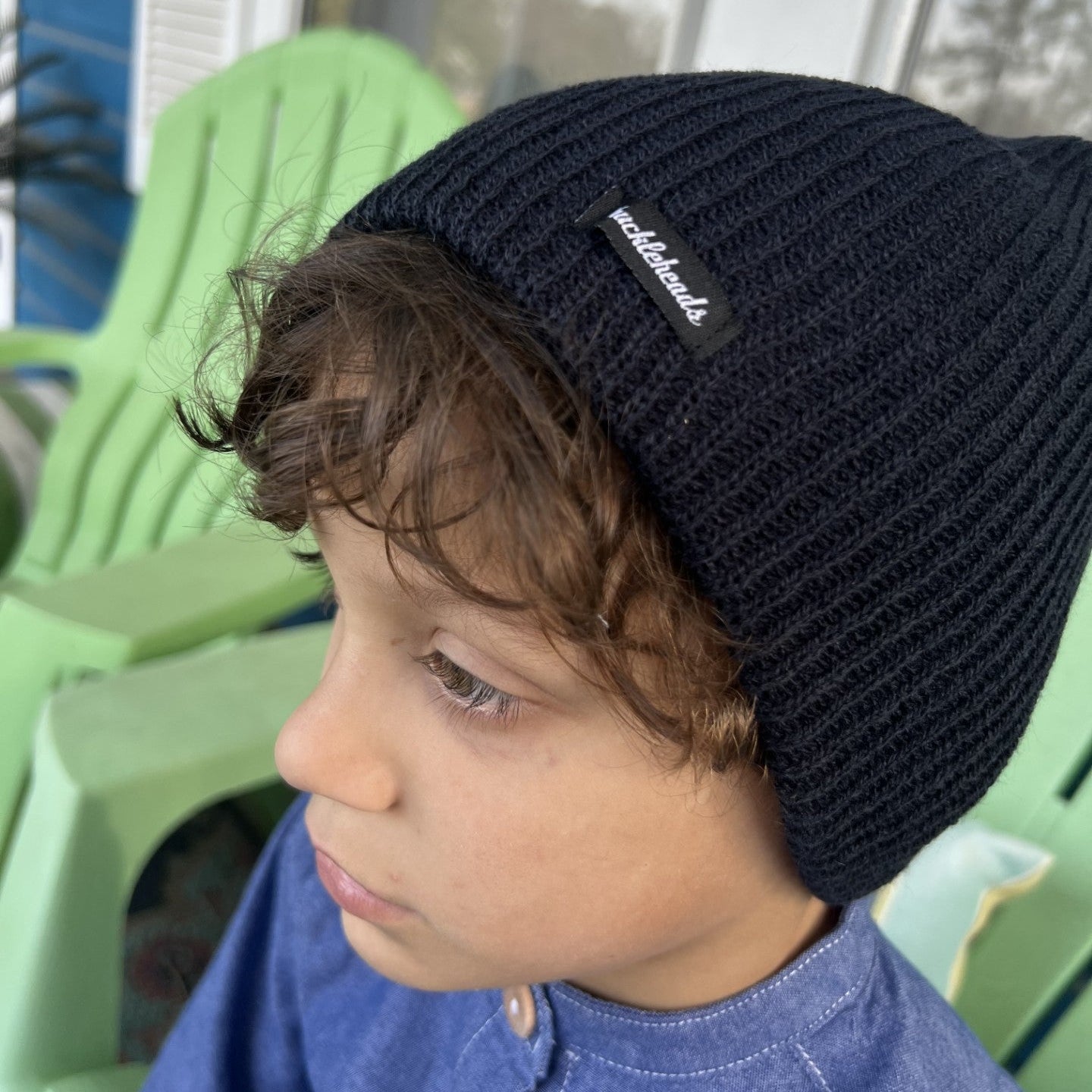 boy wearing a navy blue slouch beanie