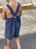 Load image into Gallery viewer, back view of the romper showing the two straps buttoned with a single wood button at the elastic waist

