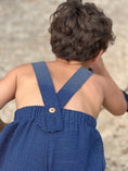 Load image into Gallery viewer, closeup of the strap detail showing the additional buttonhole for easy adjustment for the straps

